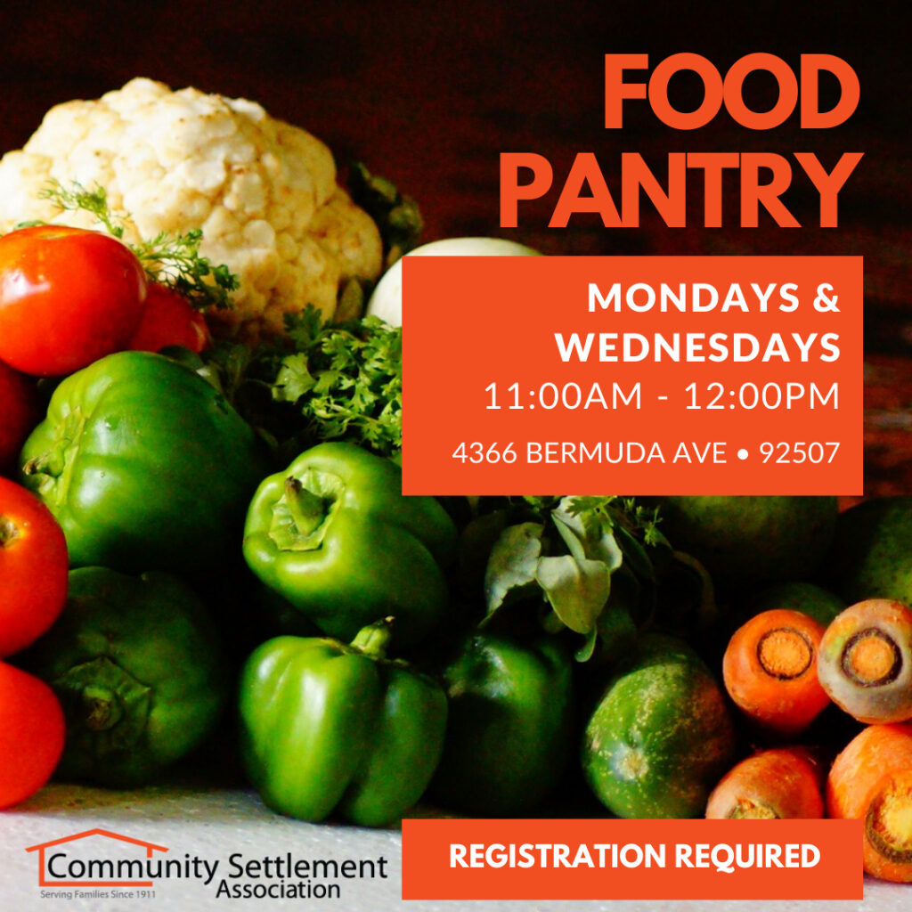 Different types of vegetables and breads showing out of a paper bag.